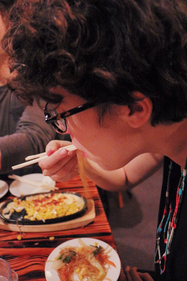 Slurping on some chap chae (with a side of corn cheese in the background!)